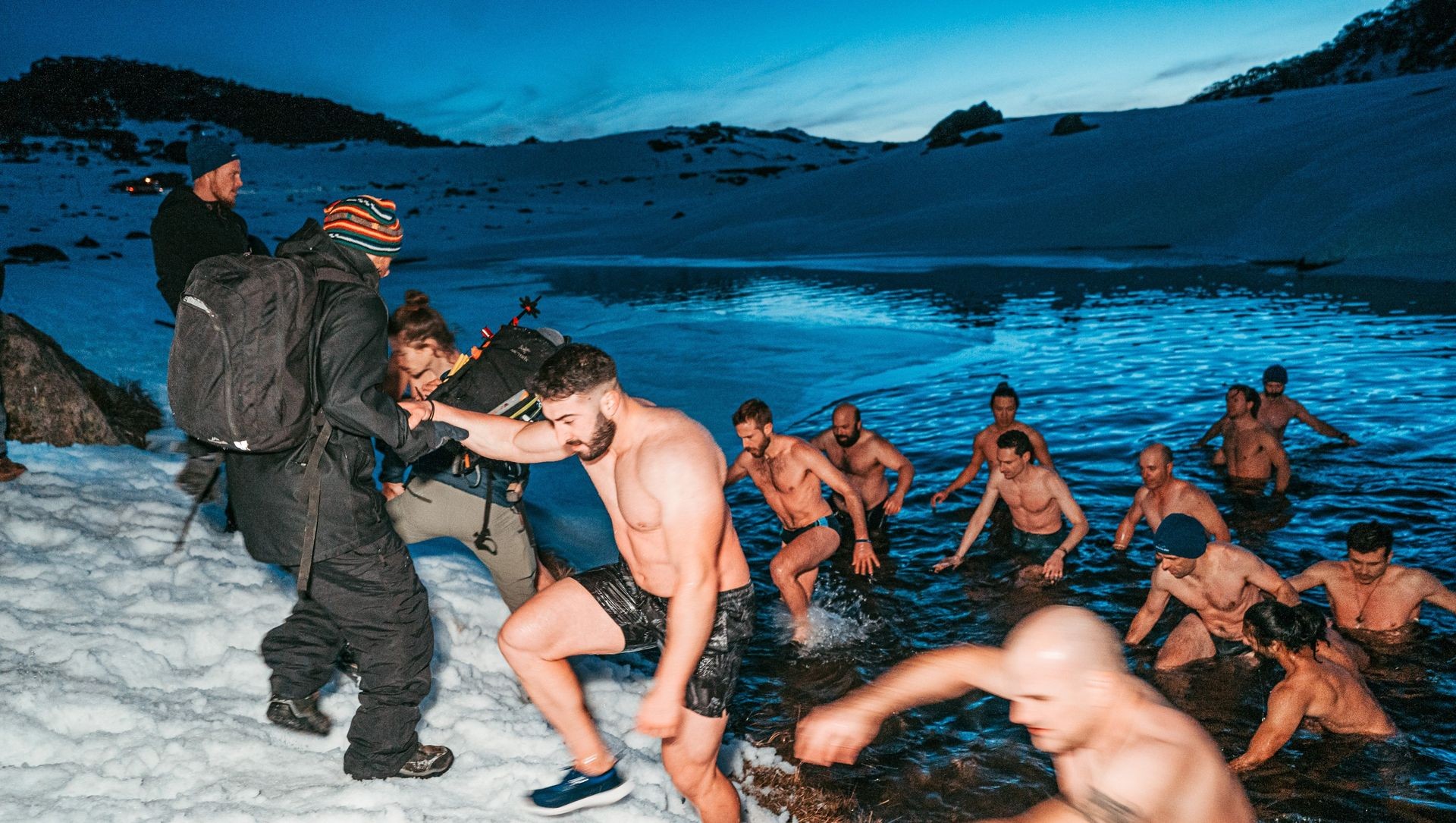 Group exiting lake with ice cold water  